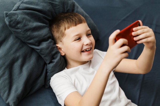 1784538135-high-view-child-playing-mobile-phone.jpg
